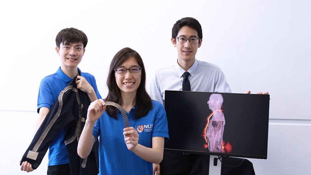 NUS researchers Tian Xi, Lee Pui Mun, and John Ho show their smart textiles.