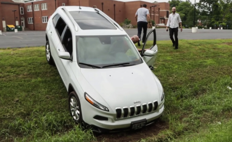 Charlie Miller drives a Jeep Cherokee out of a ditch
