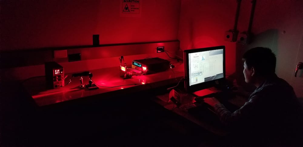 Purdue University graduate student Xiaozhe Fan measures how much light is emitted by a GaAs solar cell. The light emitted by the solar cell is modulated to convey information.